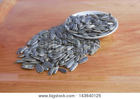 sun flower seed on wood background with selective and soft focus