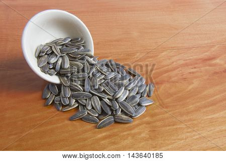 sun flower seed on wood background with selective and soft focus