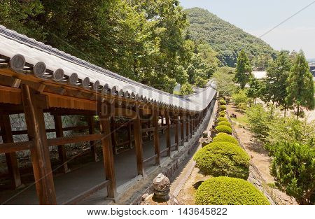 OKAYAMA JAPAN - JULY 20 2016: The 400 meter long covered walkway at Kibitsu Shinto Shrine in Okayama Prefecture. Kibitsu Shrine was the chief Shinto shrine (ichinomiya) of Bitchu Province