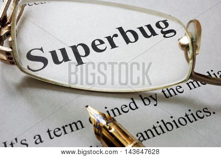 Paper with word superbug and glasses. Medical concept.
