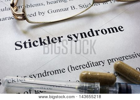 Paper with words Stickler syndrome  and glasses. Medical concept.