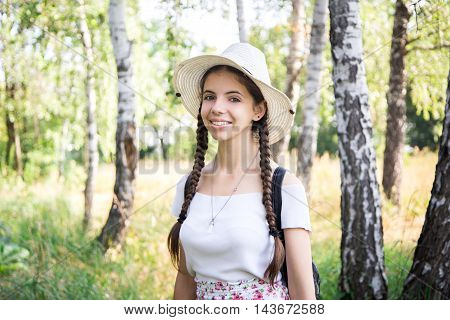Young cheerful girl in birch forest. summer