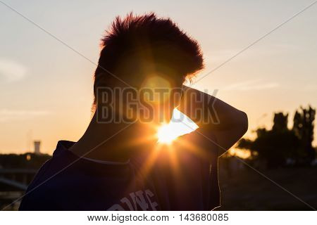 Male silhouette in the evening. Summer sunset