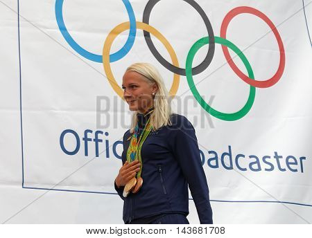 STOCKHOLM SWEDEN - AUG 21 2016: Famous swimmer Sarah Sjostrom showing her medals from the olympic games when the swedish olympics are celebrated in Kungstradgarden Stockholm Sweden August 21 2016
