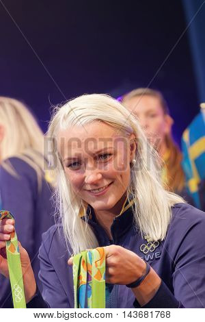 STOCKHOLM SWEDEN - AUG 21 2016: Famous swimmer Sarah Sjostrom showing her medals from the olympic games when the swedish olympics are celebrated in Kungstradgarden, Stockholm, Sweden, August 21, 2016