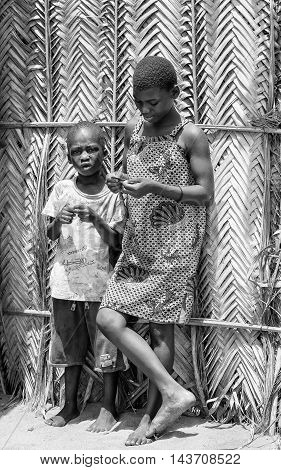 KARA, TOGO - MAR 9, 2013: Unidentified Togolese boy and girl stay in the street. Children in Togo suffer of poverty due to the unstable econimic situation