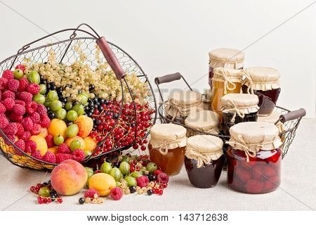 Summer fruits and berries - red black and white currants raspberries gooseberries peaches and apricots. Selective focus.