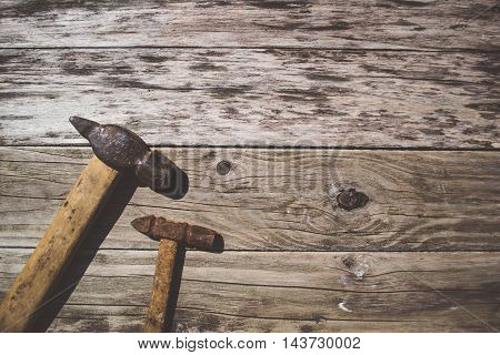 Set of old and rusty hammers on wooden background