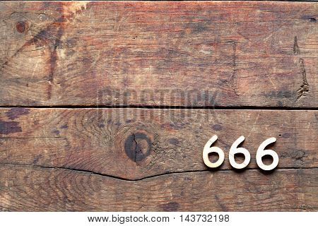 666 sign on old wooden background with free space