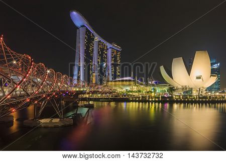 SINGAPORE SINGAPORE - SEPTEMBER 28 2013 : Singapore skyline and view of Marina Bay Sands luxury hotel which located near Helix bridge a famous landmark of Singapore.