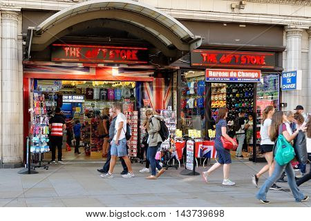 LONDON ENGLAND - JULY 8 2016: People walk past a popular souvenirs shop on Piccadilly circus. This is one of the main tourist attractions visited by millions of tourists.
