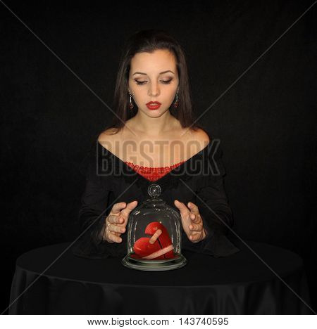The girl is standing over a broken heart.