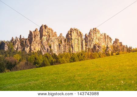 Monumental sandstone ridge of Suche Skaly, aka Dry Rocks, illuminated by summer evening sun near Mala Skala in Bohemian Paradise, Czech Republic