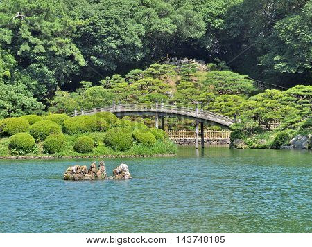 A wooden bridge - Engetsukyo in Ritsurin Garden in Takamatsu city, Kagawa Prefecture, Japan. Ritsurin Garden is one of the most famous historical gardens in Japan.