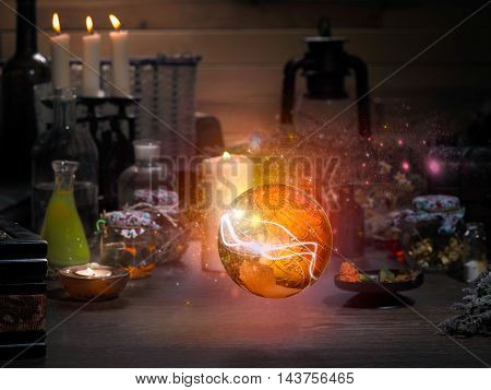 Golden Sphere. Magic items. Flasks retort for alchemy. Beautiful glow. Concept - the magician mystic paranormal phenomena. Occult esoteric spiritualism calling the spirits and ghosts