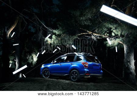 Saratov, Russia - September 28, 2015: Car Subaru Forester stand in forest concept lights at night
