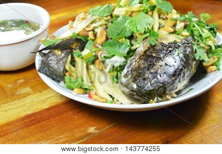 deep fried striped snake head fish with mixed herb and sweet sauce