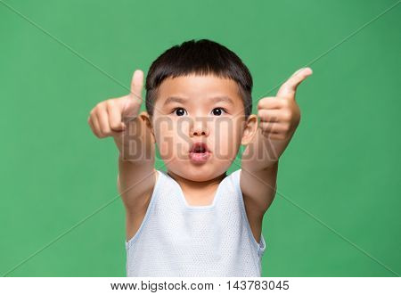 Little boy showing thumb up