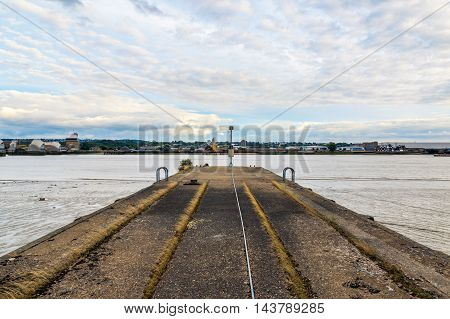 Disused concrete jetty along river near Thames Barrier