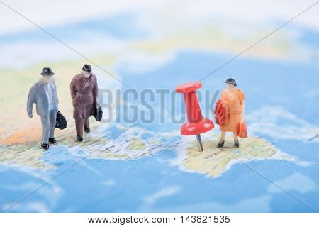 Miniature business people travel on world map. business international travel concept