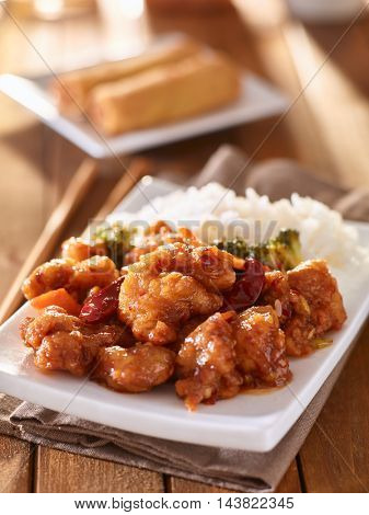 plate of chinese general tsos chicken with rice and broccoli
