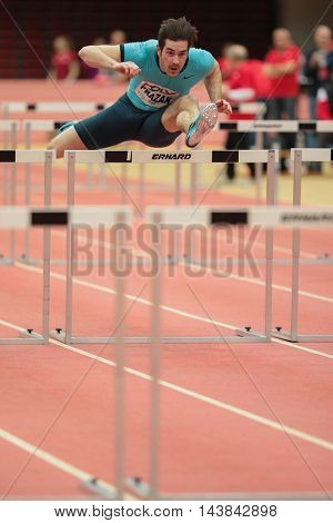 LINZ, AUSTRIA - FEBRUARY 6, 2015: Manuel Prazak (#257 Austria) competes in the men'S 60m hurdles event in an indoor track and field event.