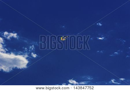 Colorful kite flying in the blue sky