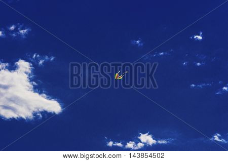 Colorful kite flying in the blue sky