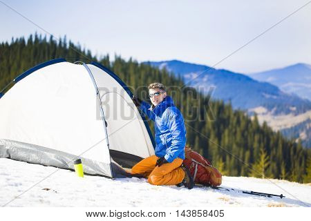 A Climber Collects Things Before Climbing Into The Mountains.