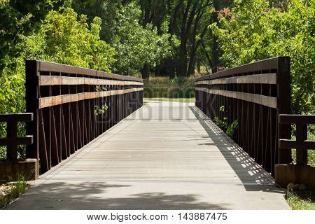 A foot bridge spanning a small river in Colorado.