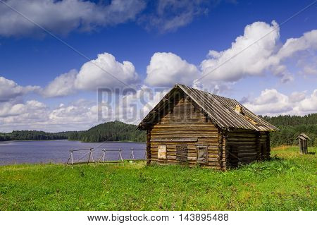 Old north Russian house on the lake shore.