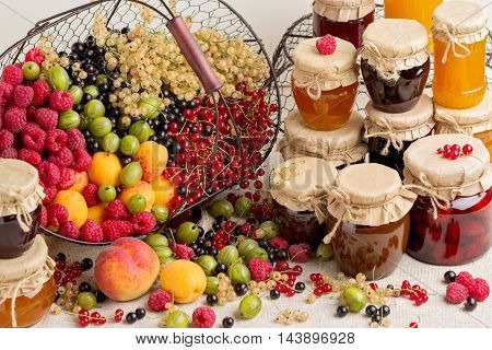 Summer fruits and berries - red black and white currants raspberries gooseberries peaches and apricots. Selective focus.