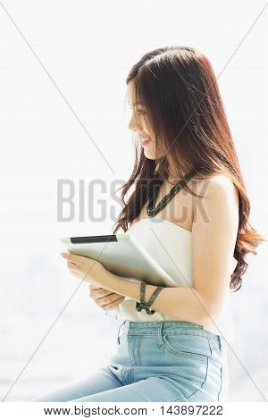 Young pretty business thai woman with tab let in the office.