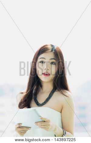 Young pretty business thai woman with tab let in the office.