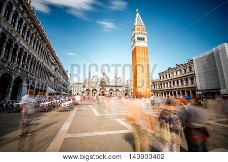 Saint Mark's square with campanille and basilica in Venice. Long exposure image technic with motion blurred people