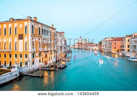 View on illuminated Grand canal with Santa Maria basilica from Accademic bridge at the dusk in Venice. Long exposure image technic