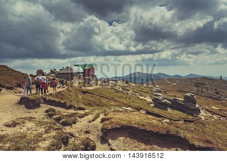 Bucegi Mountains Romania - August 6 2016: Tourists hike the trails to the Babele (The Old Women) chalet at 2206 m altitude in Bucegi Mountains to visit the Babele Rocks and the Sphinx.