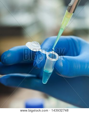 Scientist filling test tube science lab