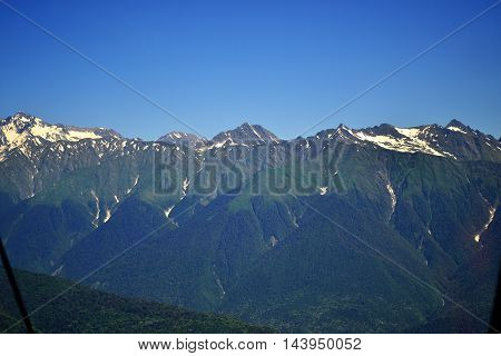 panoranic mountain landscape. valley with stones in grass on top of the hillside of mountain range in sunset light