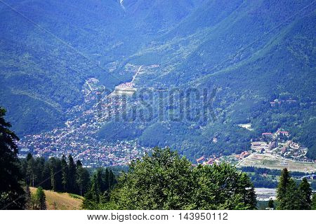panoranic mountain landscape. valley with stones in grass on top of the hillside of mountain range in sunset light