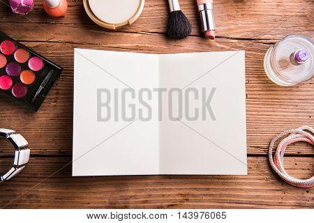 Empty Greeting Card Laid On Table. Make Up Products.
