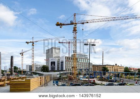 Berlin Germany - August 14 2016: Berlin under construction. View of new modern buildings and cranes from Hauptbahnhof (Central station) with Hotel Ibis in the middle and Social Court on the right.