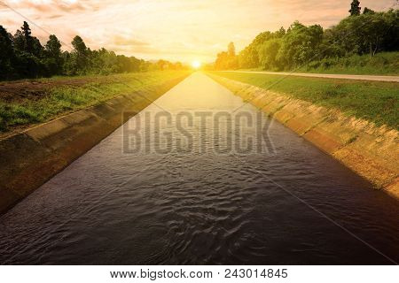 Sunrise And Isunrise And Irrigation Canal In The Rainy Season ,northern In Thailand