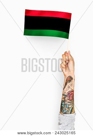 Person waving the flag of Pan-African flag