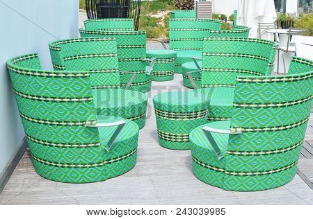 Comfortable Green Wicker Chairs And Table In A Restaurant
