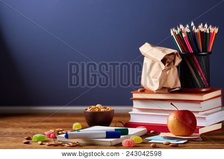 Back To School Concept, School Supplies, Assortment Of Biscuits And Transparent Lunchbox Full Of San