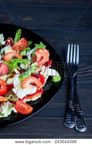 Fresh Salad From Different Vegetables And Tasty Shrimps In A Plate On The Table