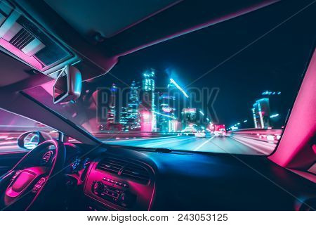 Car Speed Drive On The Road In Night City. Retro Wave Neon Noir Lights Color Toning