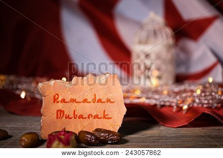 Ramadan Mubarak Is Written On A Piece Of Paper. Tunisian Flag. Closeup