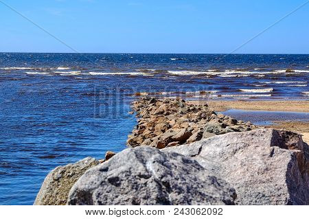 Sandy Beach, Pieces Of Dried Cane, Stone Wall